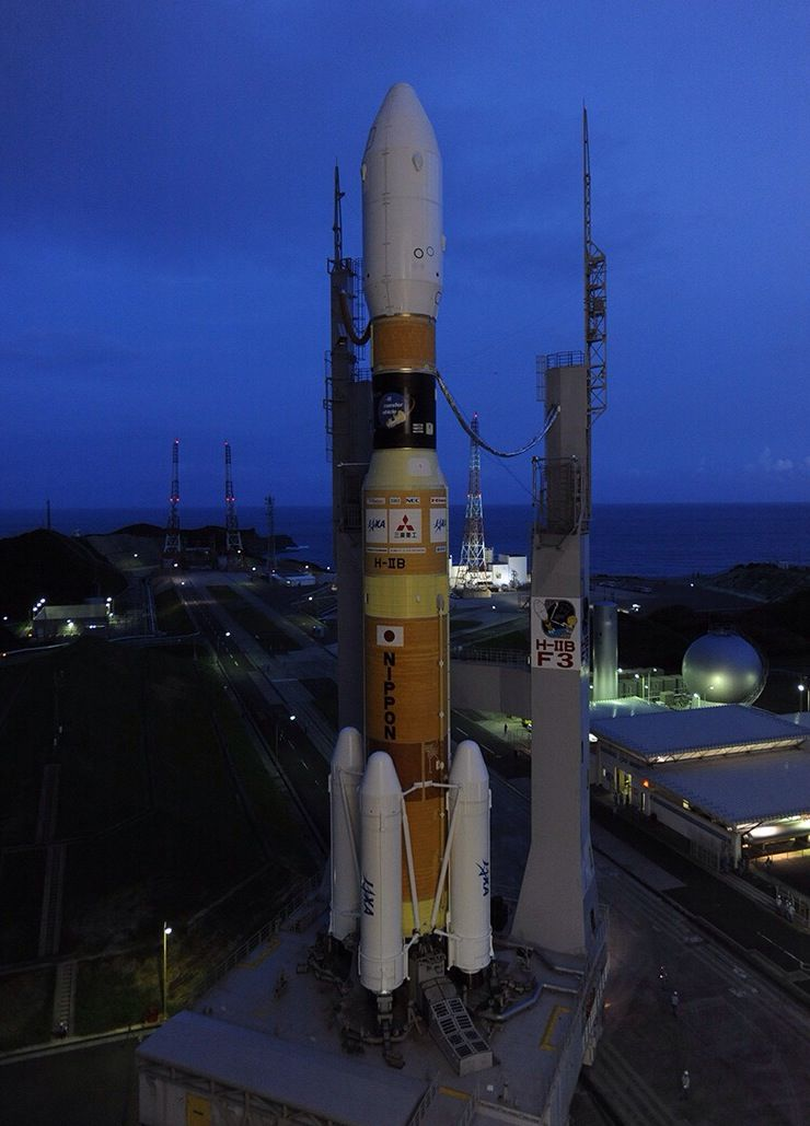A H-IIB rocket during rollout to its launch pad.